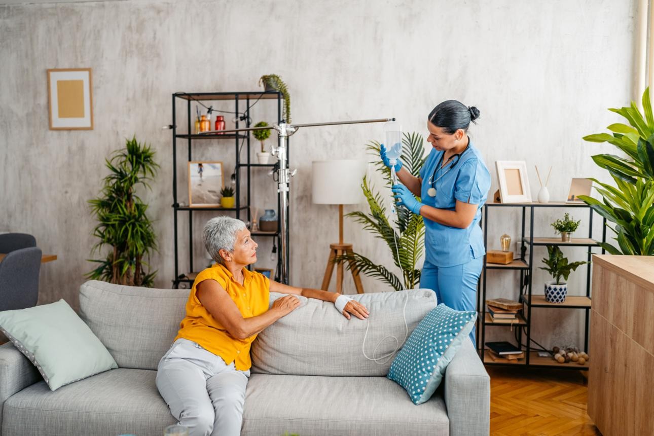 Medical professional monitoring IV infusion equipment in a clinical setting