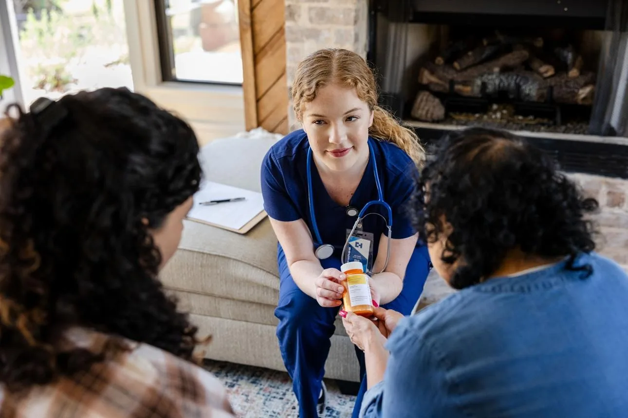 A nurse consulting with a client about medications in a comfortable home setting