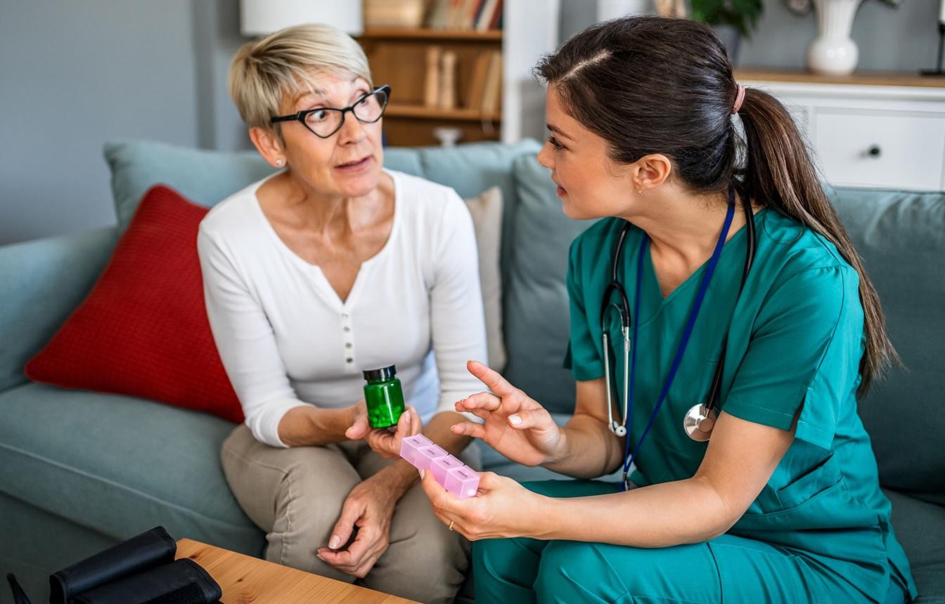 Nurse providing compassionate care to a patient at home