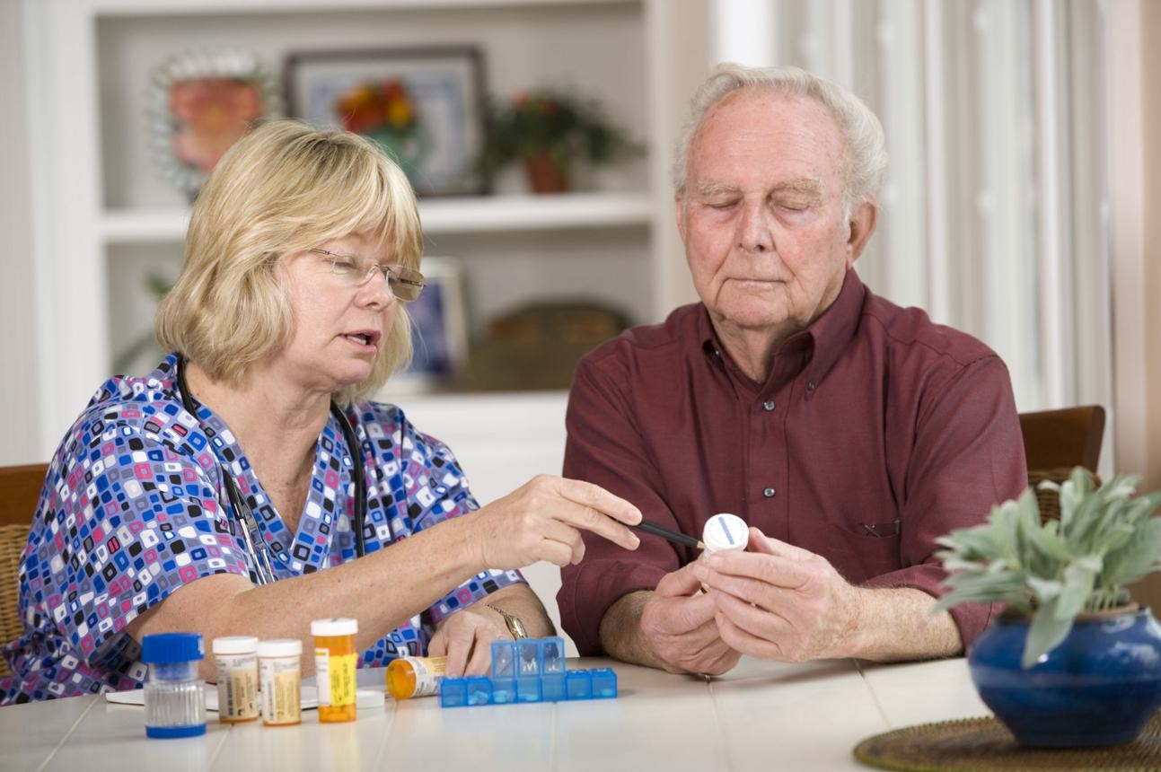 Professional caregiver supporting an assisted living resident
