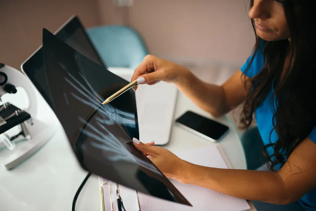 A clinician reviewing care records to plan a Dallas patient's discharge from hospital to home