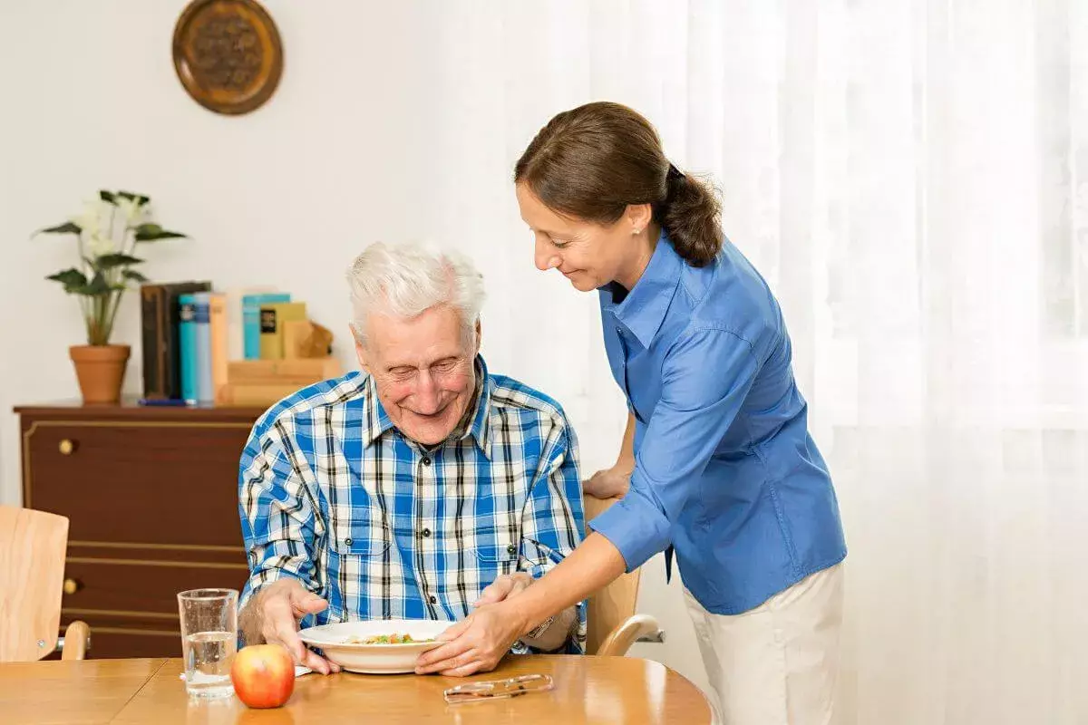 Caregiver supporting a parent with dementia at home in Dallas