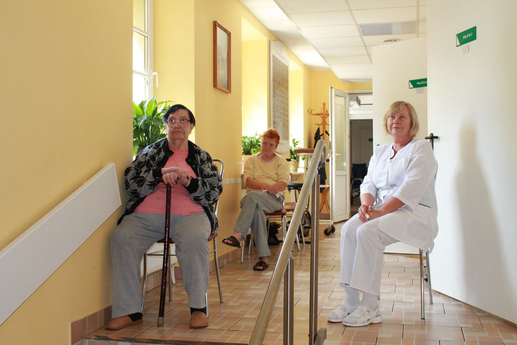 A caregiver and seniors in a memory care community setting