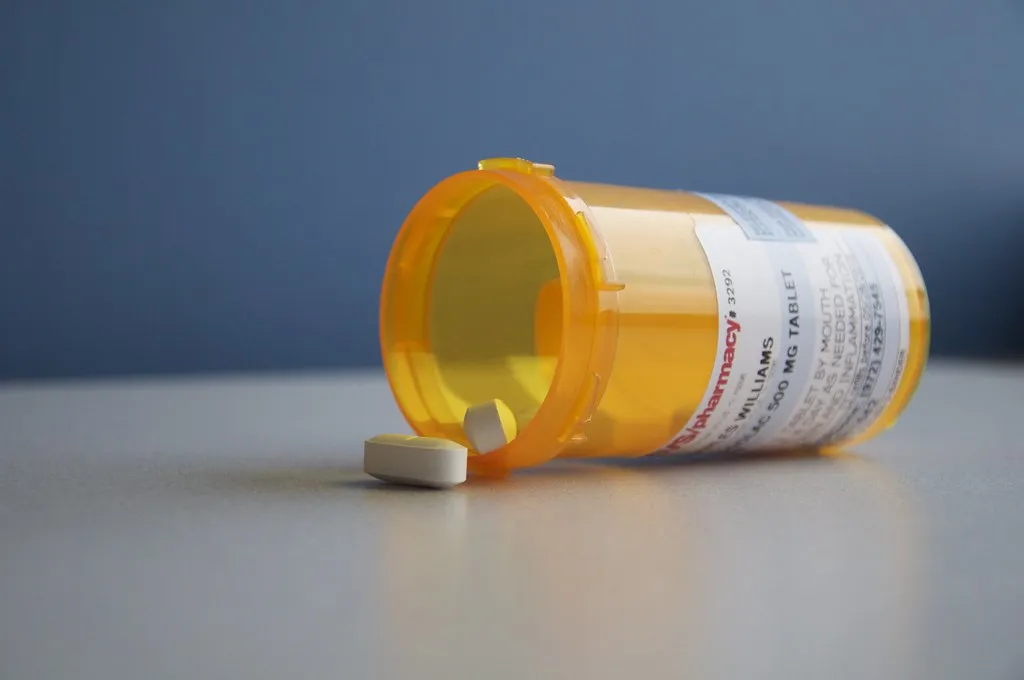 A prescription medication bottle with pills, representing a home medication routine