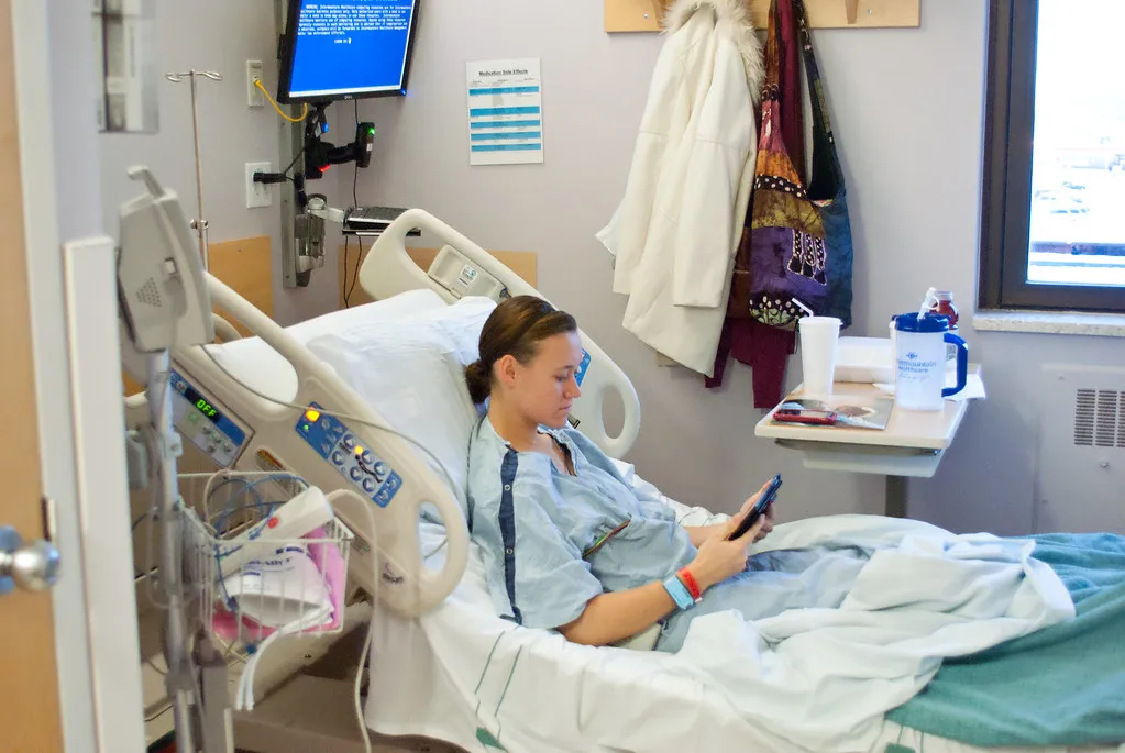A patient resting in a hospital bed before returning home to recover